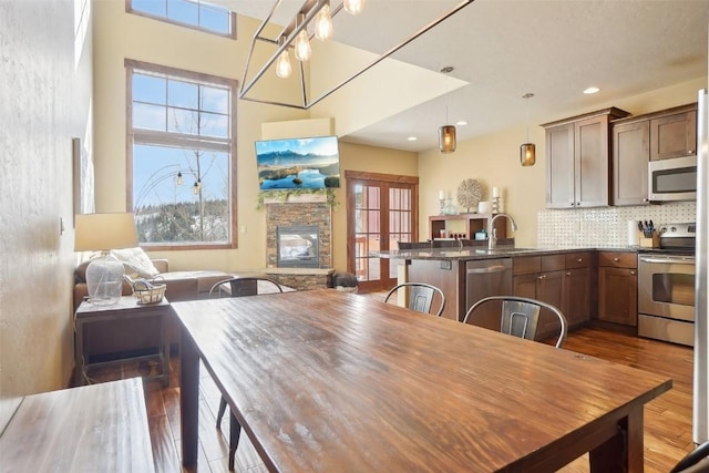 0050 County Road 1293 Unit B, Silverthorne, CO 80498 - dining space featuring a fireplace, wood finished floors, and recessed lighting