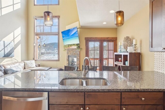 0050 County Road 1293 Unit B, Silverthorne, CO 80498 - kitchen with a sink, dark stone counters, open floor plan, dishwasher, and decorative light fixtures