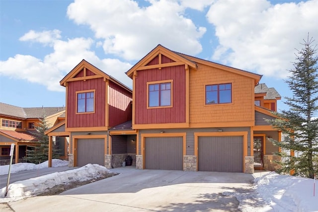 0050 County Road 1293 Unit B, Silverthorne, CO 80498 - view of front of house featuring a garage, stone siding, and concrete driveway