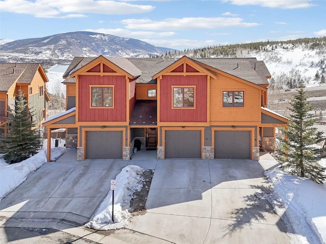 0050 County Road 1293 Unit B, Silverthorne, CO 80498 - view of front facade featuring a garage, driveway, and stone siding