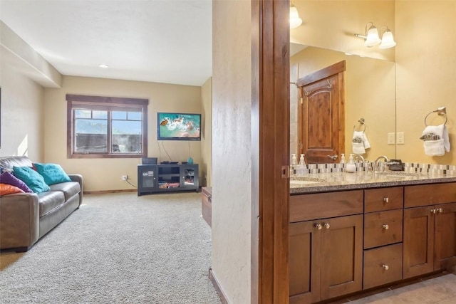 0050 County Road 1293 Unit B, Silverthorne, CO 80498 - bathroom featuring baseboards, a sink, and double vanity