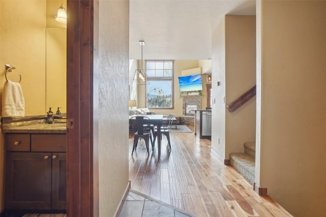 0050 County Road 1293 Unit B, Silverthorne, CO 80498 - hallway with baseboards, light wood-style floors, and stairway