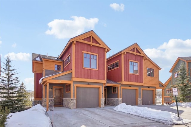 0050 County Road 1293 Unit B, Silverthorne, CO 80498 - view of front of property with an attached garage, board and batten siding, stone siding, and concrete driveway