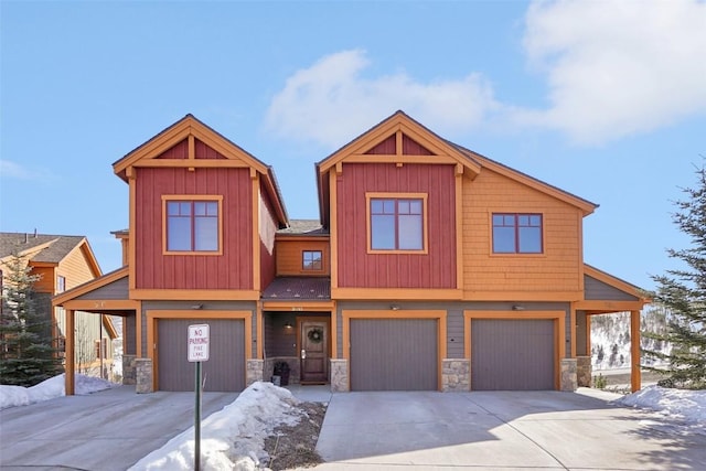 0050 County Road 1293 Unit B, Silverthorne, CO 80498 - view of front of house with an attached garage, stone siding, and concrete driveway