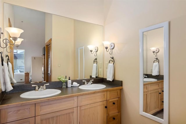 full bathroom with a sink and double vanity