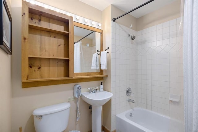 bathroom with a sink, shower / bathtub combination with curtain, and toilet