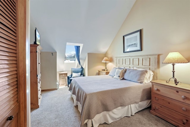 bedroom featuring lofted ceiling and light colored carpet