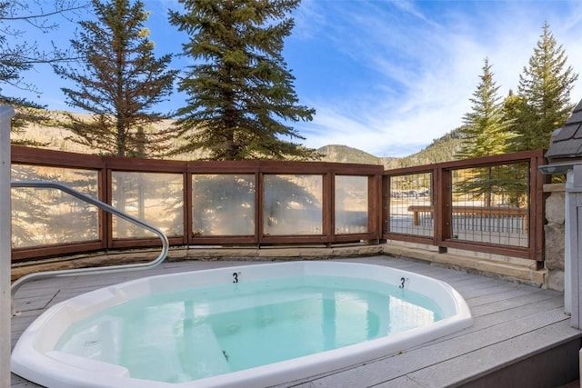 view of pool featuring hot tub deck surround