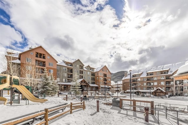 view of community featuring fence and playground community