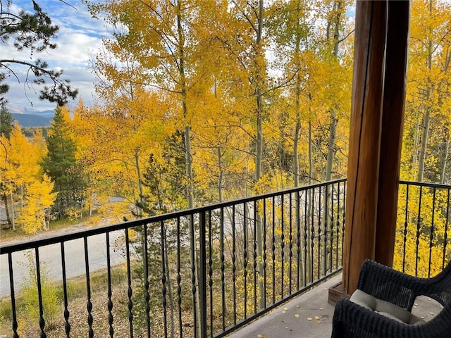 balcony featuring a forest view