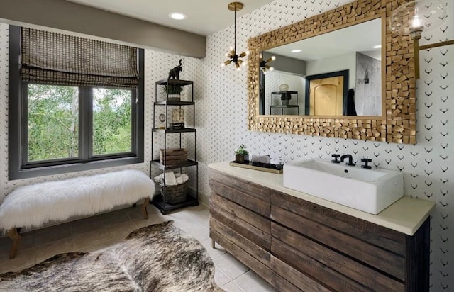 bathroom with vanity, a chandelier, and tile patterned floors