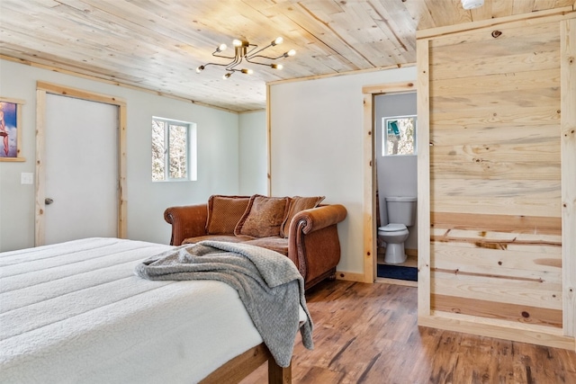 bedroom featuring wooden ceiling, an inviting chandelier, ensuite bath, and wood finished floors