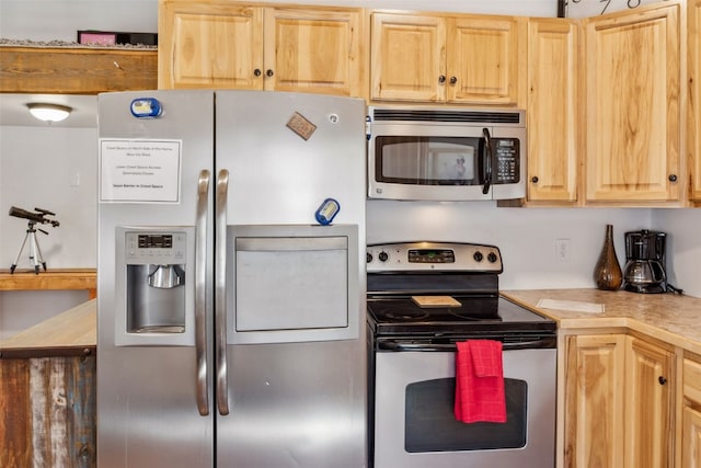 kitchen with light brown cabinets, light countertops, and appliances with stainless steel finishes