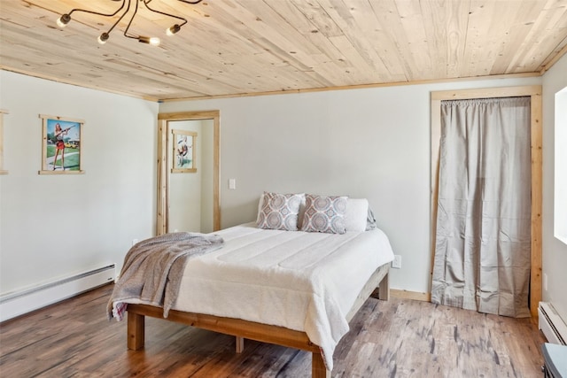 bedroom with wood ceiling, wood finished floors, and a baseboard radiator
