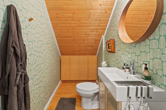 433 Fremont Knoll Ln, Jefferson, CO 80456 - half bath with wallpapered walls, wooden ceiling, toilet, wood finished floors, and vanity