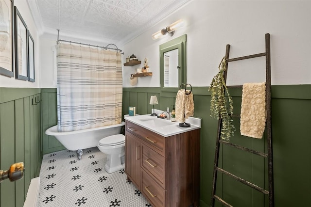 433 Fremont Knoll Ln, Jefferson, CO 80456 - bathroom featuring vanity, toilet, ornamental molding, wainscoting, and shower / bath combo with shower curtain