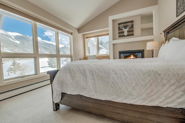 40 Fairway Ln Unit 31, Copper Mountain, CO 80443 - carpeted bedroom with a glass covered fireplace, vaulted ceiling, a baseboard heating unit, and a mountain view