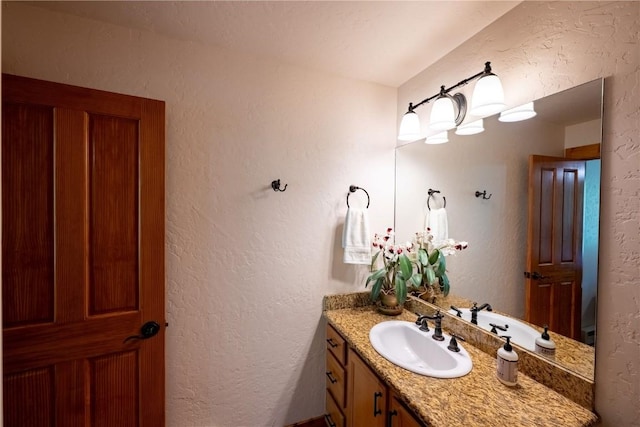 580 Anglers Dr Unit 204, Steamboat Springs, CO 80487 - bathroom featuring vanity and a textured wall