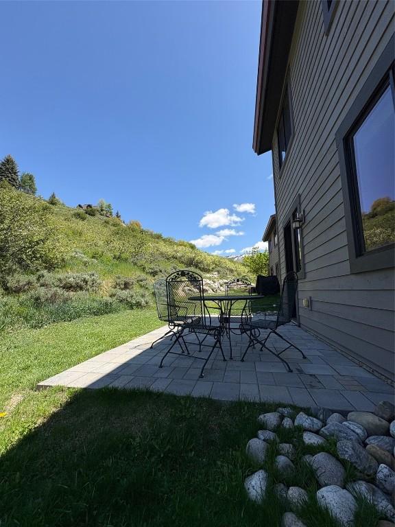 580 Anglers Dr Unit 204, Steamboat Springs, CO 80487 - view of grassy yard featuring a patio