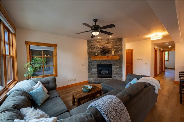 580 Anglers Dr Unit 204, Steamboat Springs, CO 80487 - living room featuring ceiling fan, light wood-type flooring, baseboards, and a fireplace