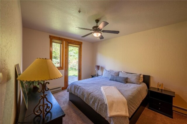 580 Anglers Dr Unit 204, Steamboat Springs, CO 80487 - bedroom featuring a baseboard heating unit, carpet floors, a baseboard radiator, access to exterior, and a textured wall