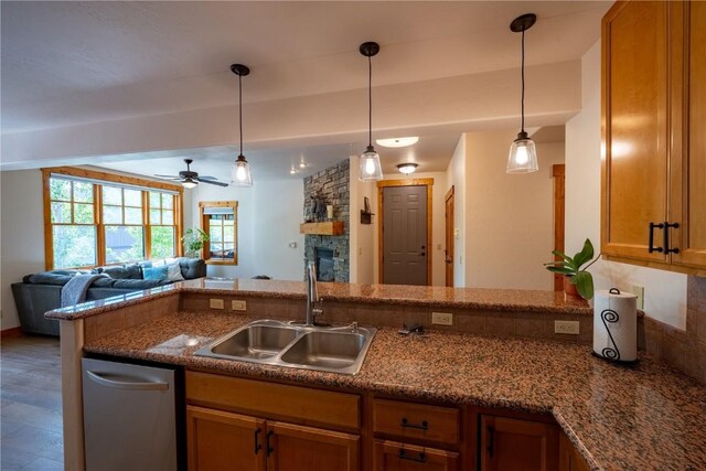 580 Anglers Dr Unit 204, Steamboat Springs, CO 80487 - kitchen with a sink, a fireplace, open floor plan, hanging light fixtures, and a ceiling fan