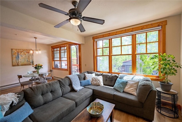 580 Anglers Dr Unit 204, Steamboat Springs, CO 80487 - living area with wood finished floors, a chandelier, plenty of natural light, and a baseboard radiator