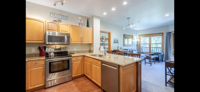 22714 US Highway 6 Unit 5989, Keystone, CO 80435 - kitchen featuring a peninsula, light stone countertops, appliances with stainless steel finishes, and a sink