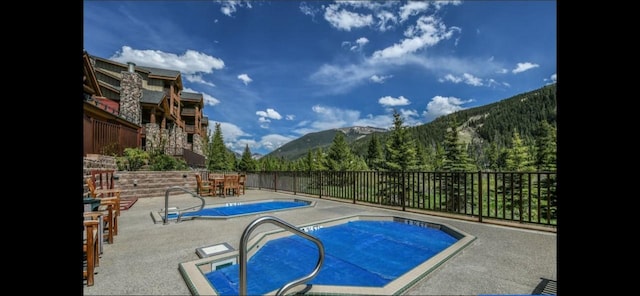 22714 US Highway 6 Unit 5989, Keystone, CO 80435 - pool with a mountain view, fence, and a patio area