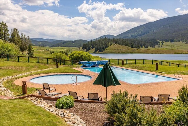 82 Potentilla Ln, Keystone, CO 80435 - view of swimming pool with a fenced in pool, a lawn, fence, and a water and mountain view