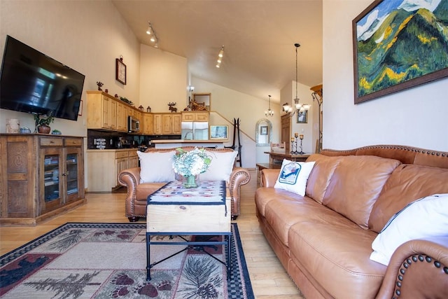 631 Parkview Dr, Steamboat Springs, CO 80487 - living room with a chandelier, light wood finished floors, and high vaulted ceiling