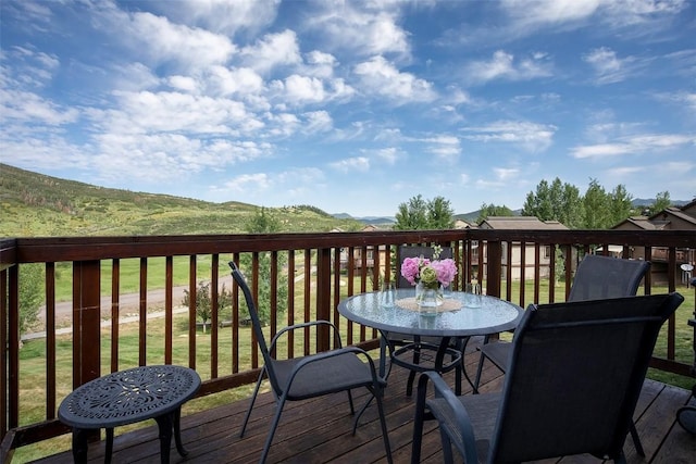 631 Parkview Dr, Steamboat Springs, CO 80487 - wooden deck featuring outdoor dining area and a mountain view