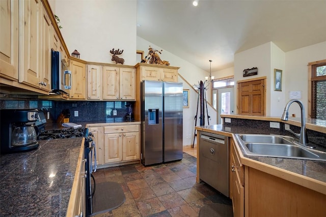 631 Parkview Dr, Steamboat Springs, CO 80487 - kitchen with appliances with stainless steel finishes, light brown cabinets, backsplash, vaulted ceiling, and dark stone finish flooring