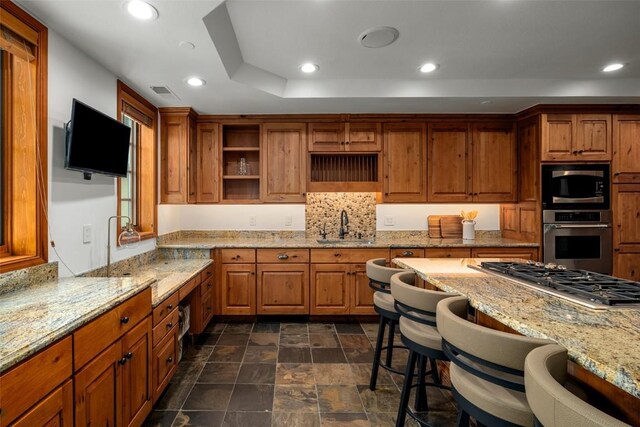 2600 Eagleridge Dr Unit 26, Steamboat Springs, CO 80487 - kitchen featuring appliances with stainless steel finishes, open shelves, brown cabinetry, and recessed lighting
