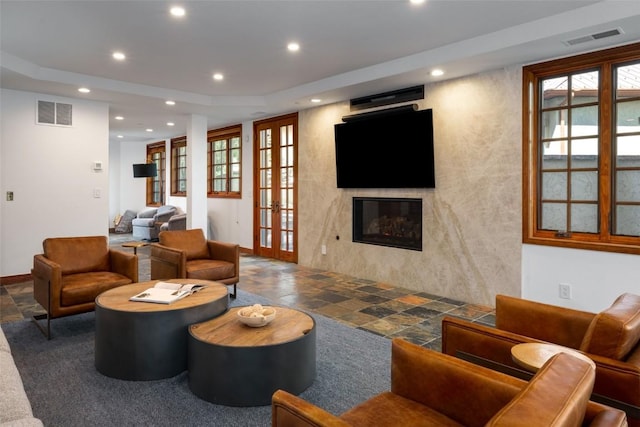2600 Eagleridge Dr Unit 26, Steamboat Springs, CO 80487 - living room with recessed lighting, plenty of natural light, a fireplace, stone finish flooring, and baseboards