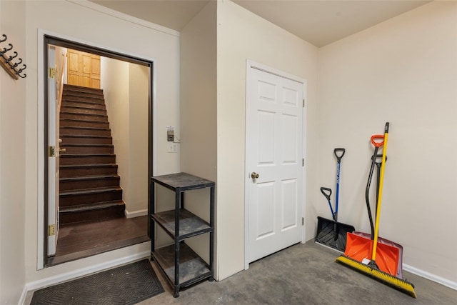 hallway featuring stairway and baseboards