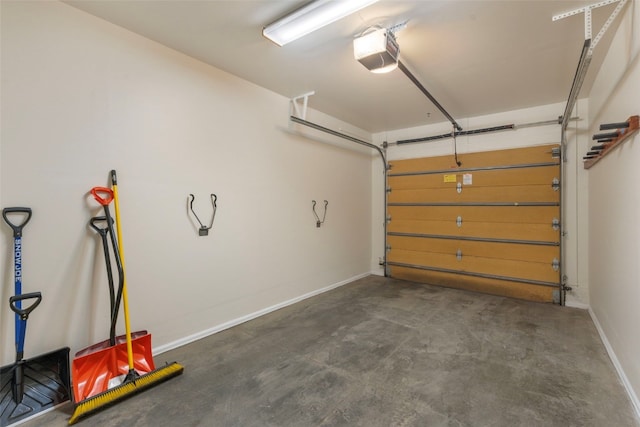 garage with a garage door opener and baseboards