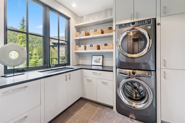628 Independence Rd, Keystone, CO 80435 - laundry area with estacked washer and dryer, cabinet space, tile patterned flooring, and recessed lighting