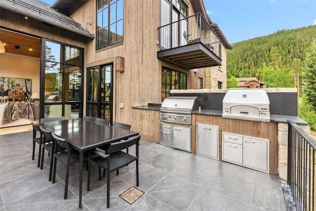 628 Independence Rd, Keystone, CO 80435 - patio / terrace with a wooded view, area for grilling, outdoor dining space, and a patio area