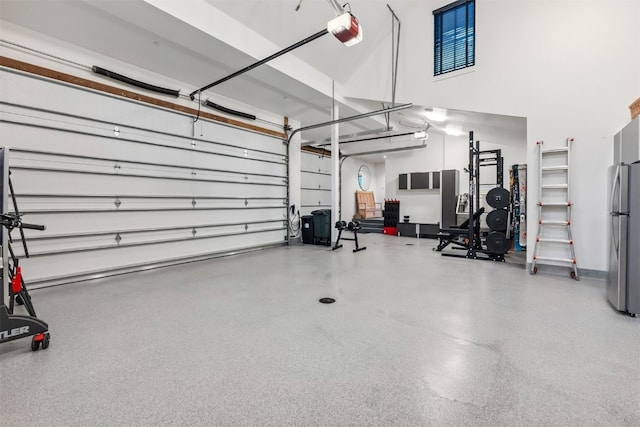 628 Independence Rd, Keystone, CO 80435 - garage featuring a garage door opener and freestanding refrigerator