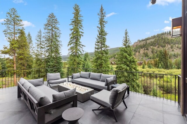 628 Independence Rd, Keystone, CO 80435 - view of patio / terrace with an outdoor living space with a fire pit and a forest view