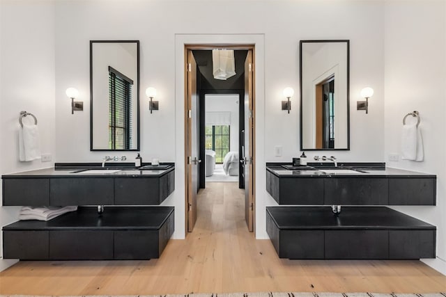 628 Independence Rd, Keystone, CO 80435 - bathroom with wood finished floors, two vanities, and connected bathroom