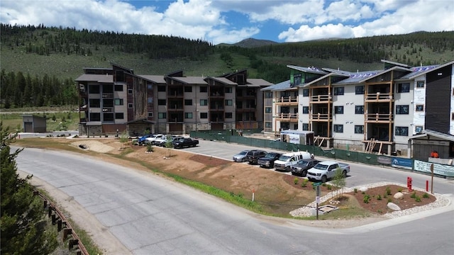 35 Argentine Ct Unit 204, Keystone, CO 80435 - view of apartment building / complex featuring a wooded view, uncovered parking, and a mountain view