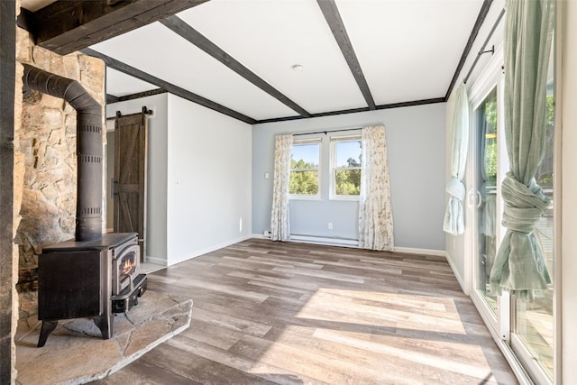 8011 Ryan Gulch Rd Unit B2, Silverthorne, CO 80498 - unfurnished living room featuring wood finished floors, beam ceiling, a wood stove, crown molding, and a baseboard heating unit