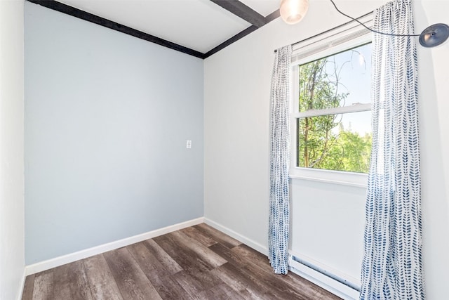 8011 Ryan Gulch Rd Unit B2, Silverthorne, CO 80498 - spare room featuring a baseboard heating unit, dark wood-type flooring, and crown molding