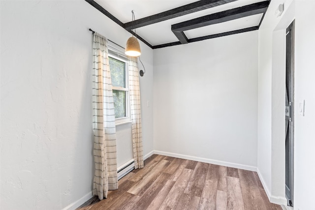 8011 Ryan Gulch Rd Unit B2, Silverthorne, CO 80498 - empty room with a baseboard radiator and wood finished floors