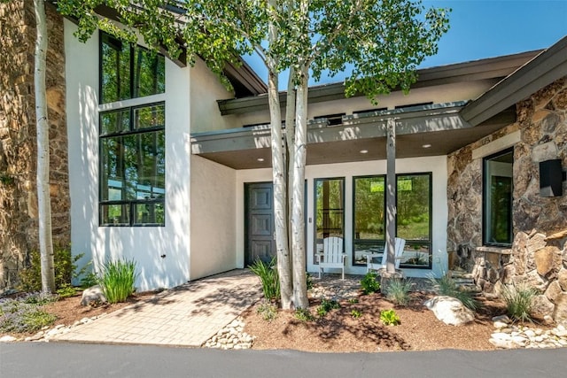 36125 Quarry Ridge Rd, Steamboat Springs, CO 80487 - doorway to property with stone siding and stucco siding