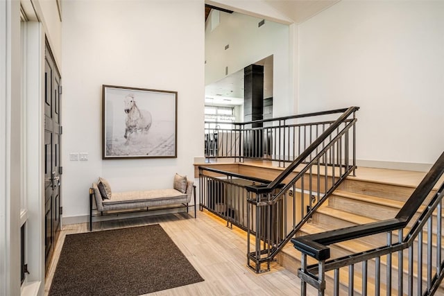 36125 Quarry Ridge Rd, Steamboat Springs, CO 80487 - stairway featuring wood finished floors, baseboards, and high vaulted ceiling