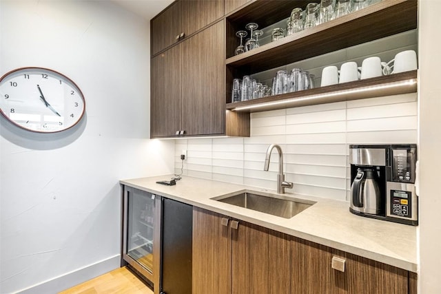36125 Quarry Ridge Rd, Steamboat Springs, CO 80487 - bar with a sink, backsplash, wine cooler, baseboards, and light wood-style flooring