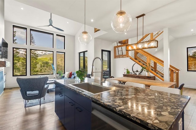 581 Fairview Blvd, Breckenridge, CO 80424 - kitchen featuring a sink, an island with sink, wood finished floors, pendant lighting, and ceiling fan
